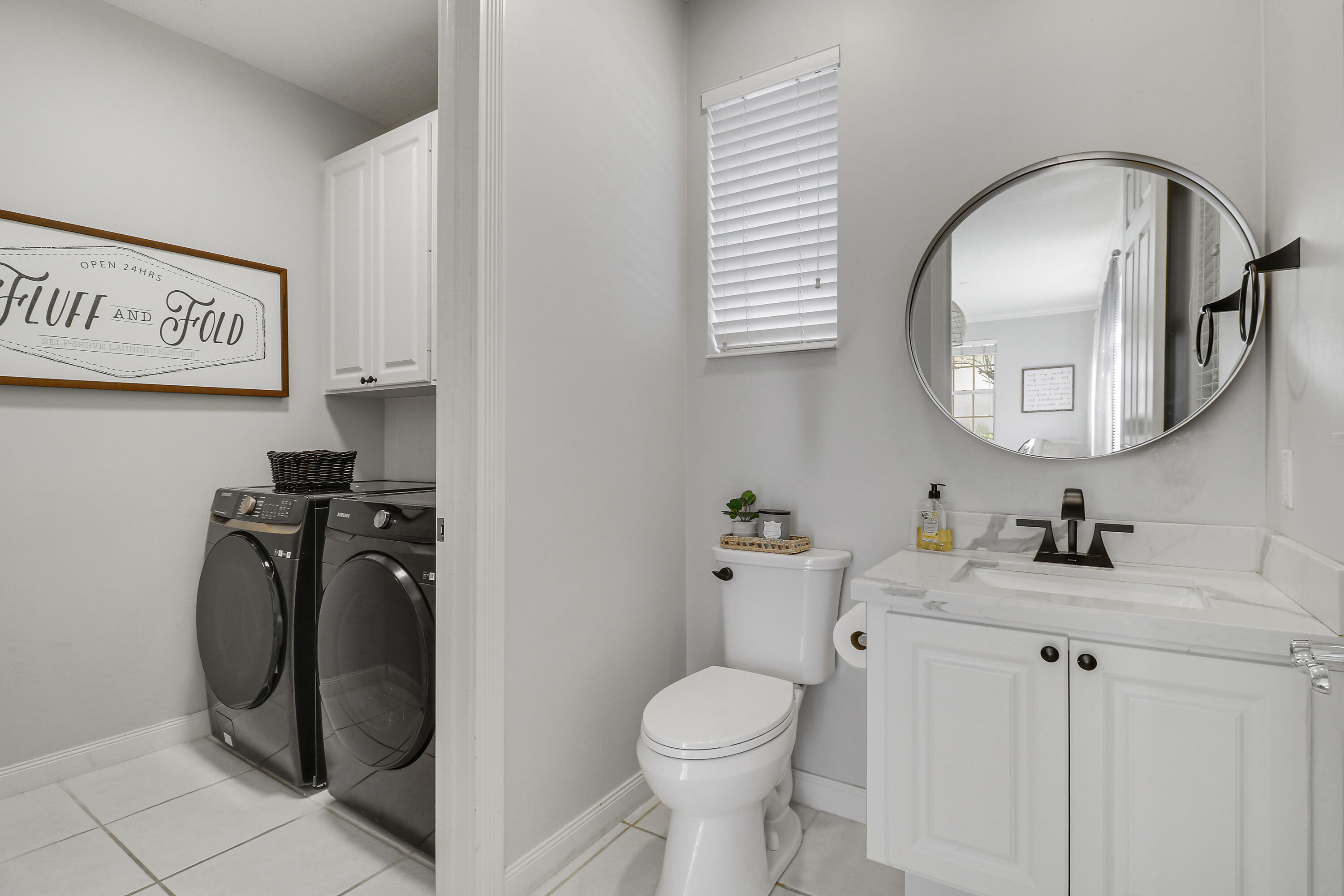 131 Rockingham Road Jupiter, FL 33458 - Photo 21 of 40 a bathroom with a toilet sink and mirror