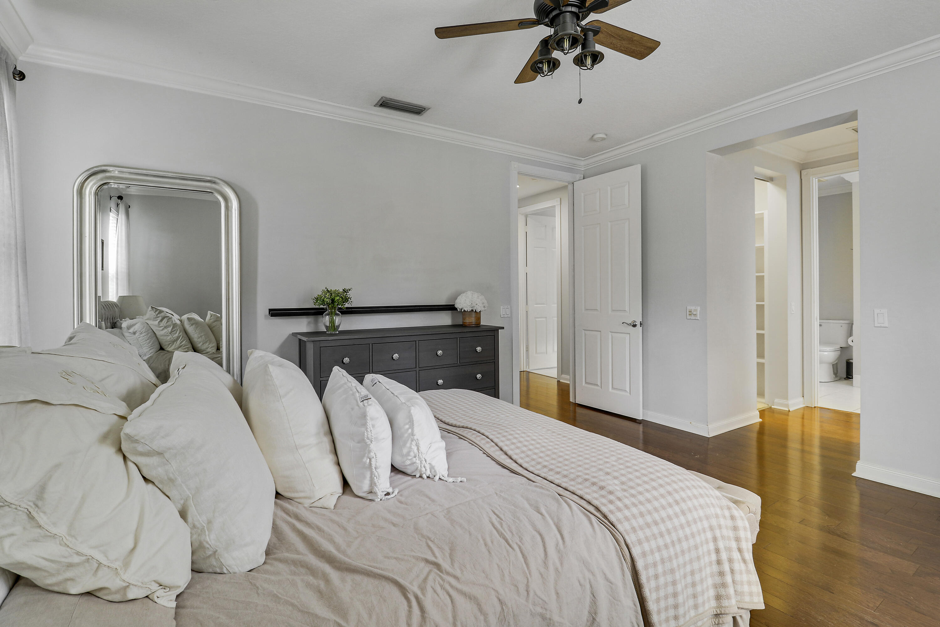 131 Rockingham Road Jupiter, FL 33458 - Photo 24 of 40 a bedroom with a bed and a chandelier