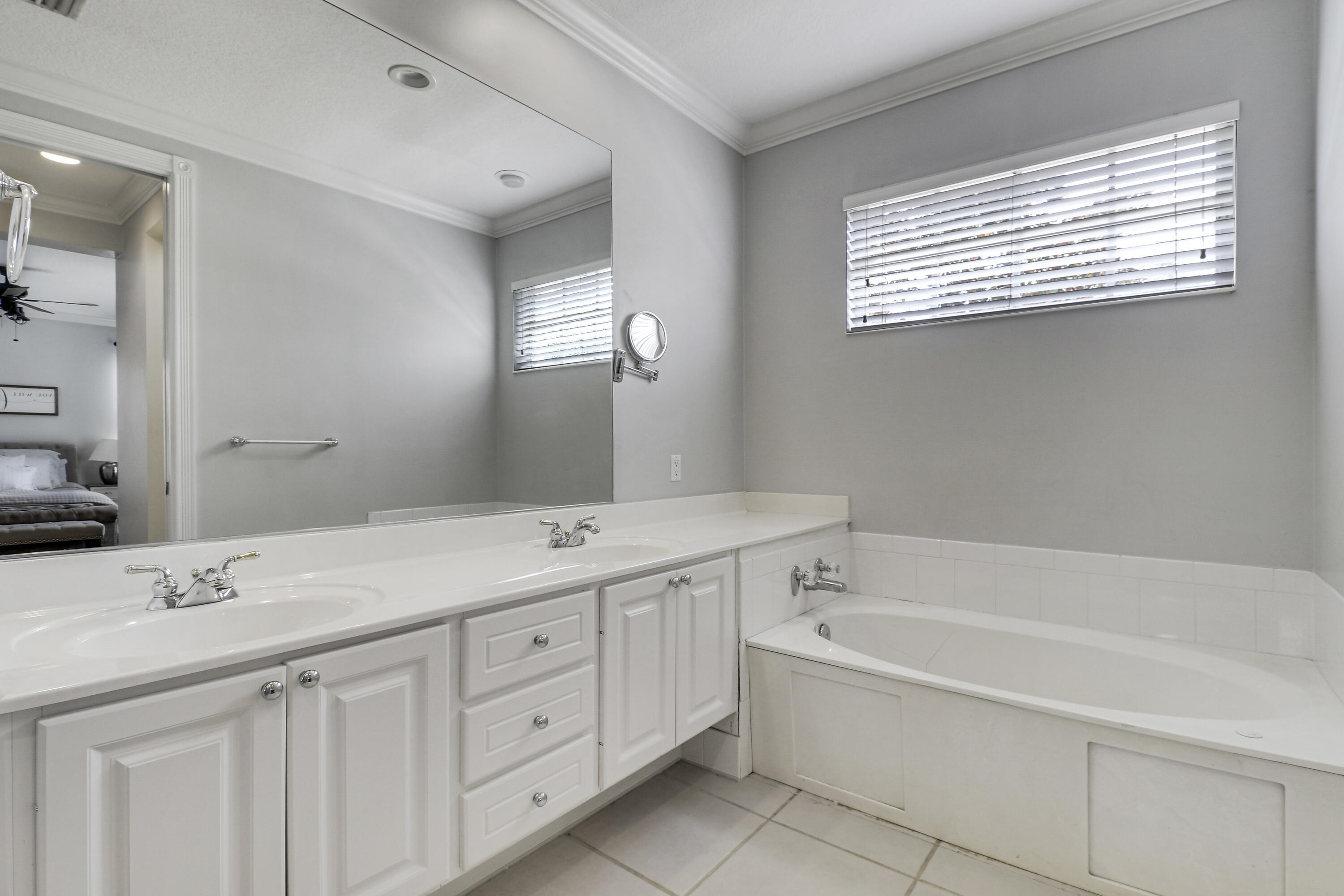 131 Rockingham Road Jupiter, FL 33458 - Photo 25 of 40 a spacious bathroom with a tub double sink and mirror