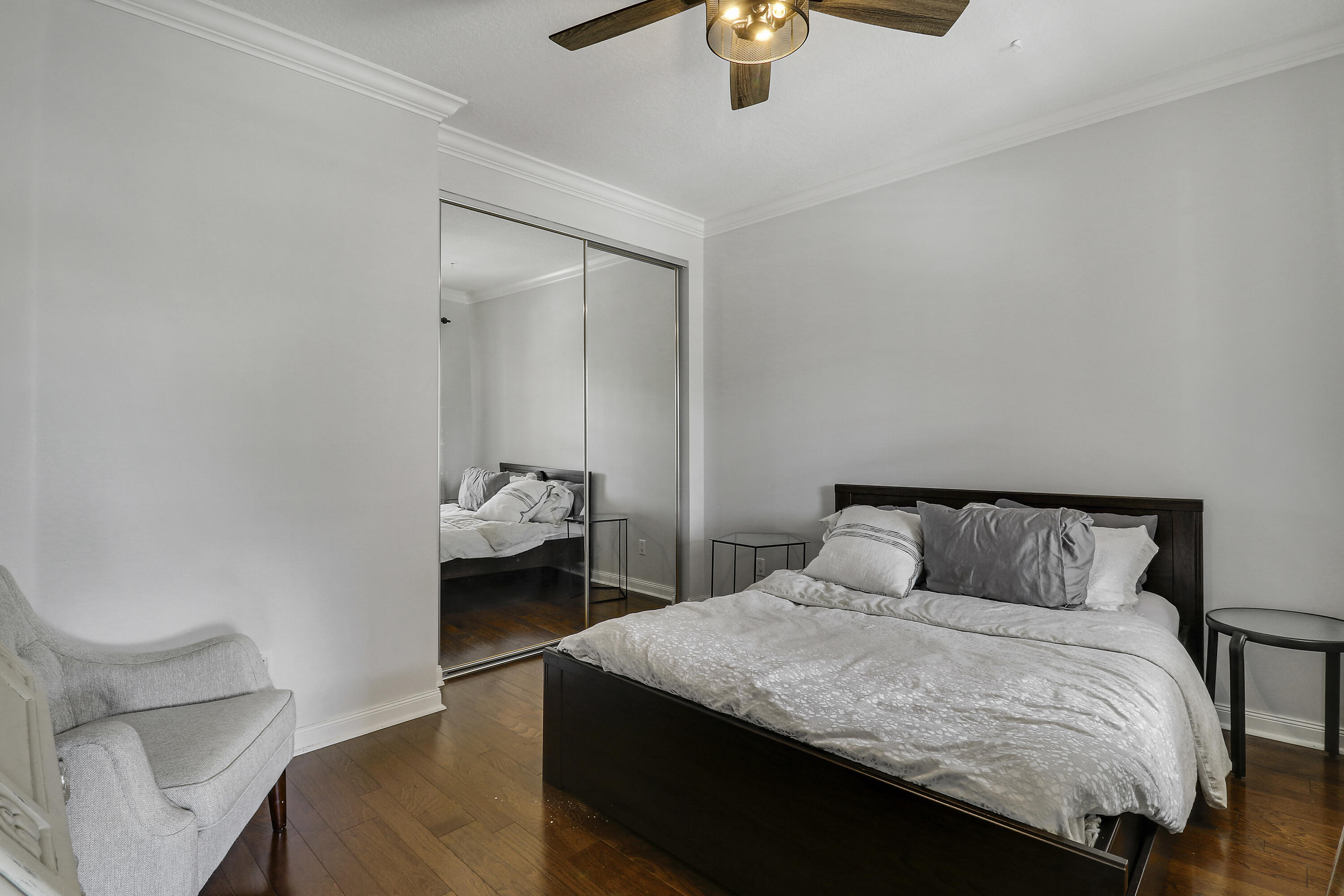 131 Rockingham Road Jupiter, FL 33458 - Photo 28 of 40 a bedroom with a bed and a chandelier