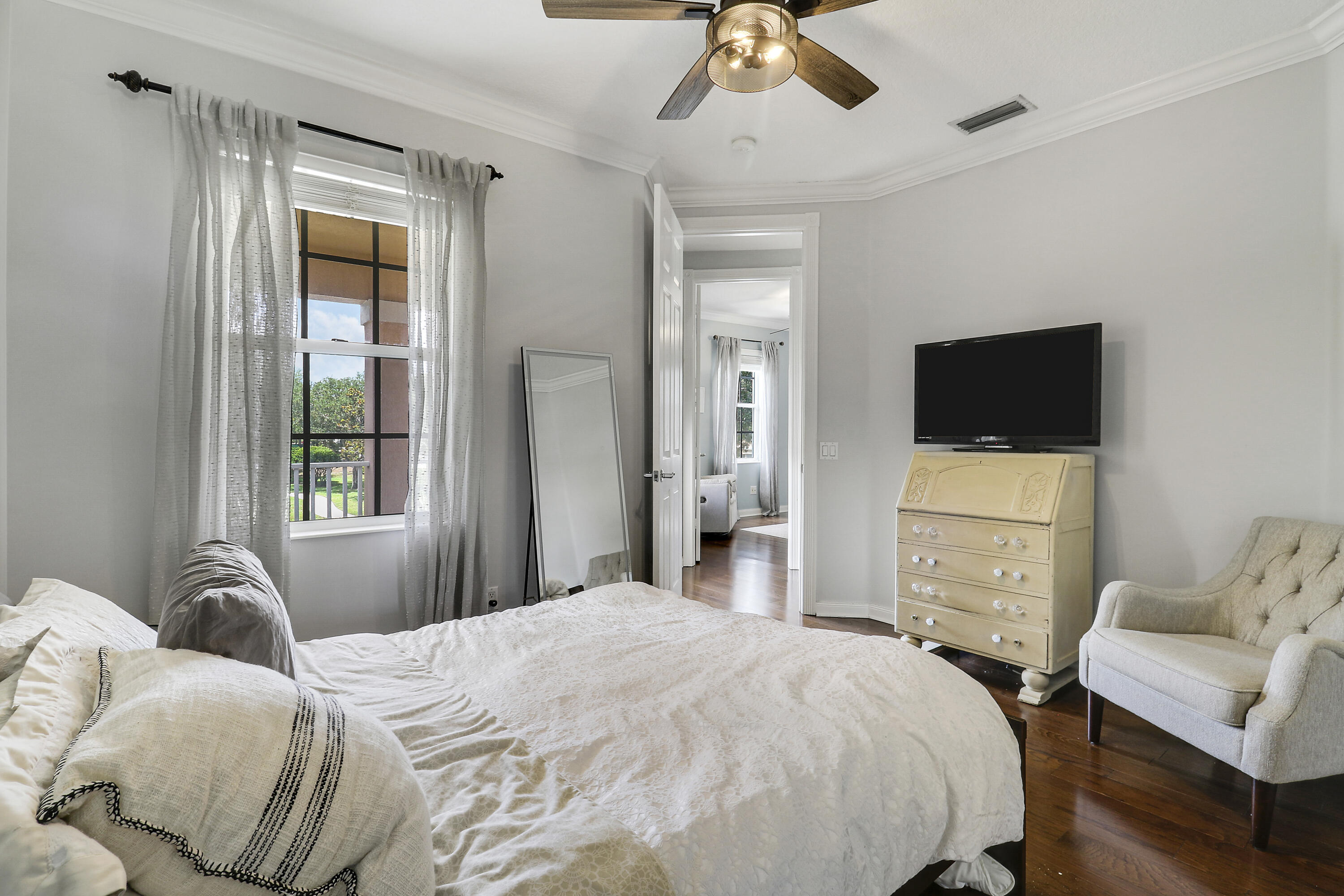 131 Rockingham Road Jupiter, FL 33458 - Photo 29 of 40 a bedroom with a bed and a television