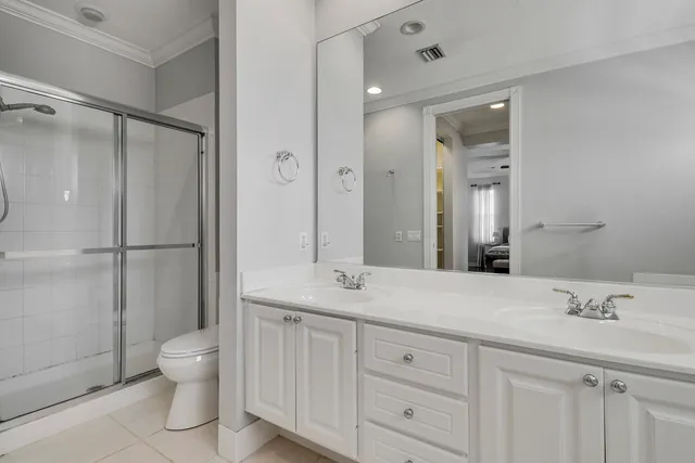 a spacious bathroom with a granite countertop sink a toilet and a mirror