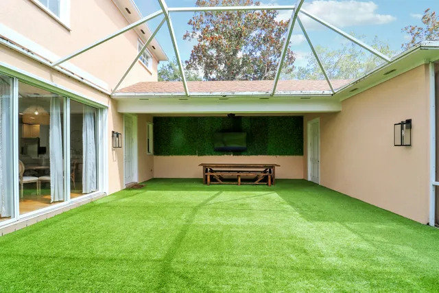 a backyard of a house with barbeque oven table and chairs