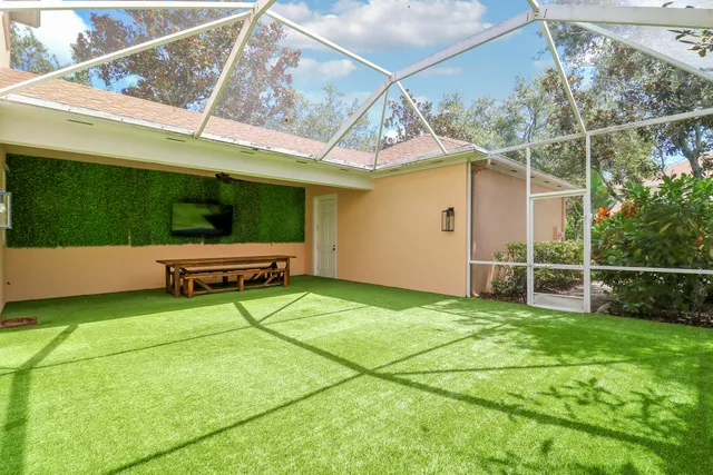a backyard of a house with barbeque oven table and chairs