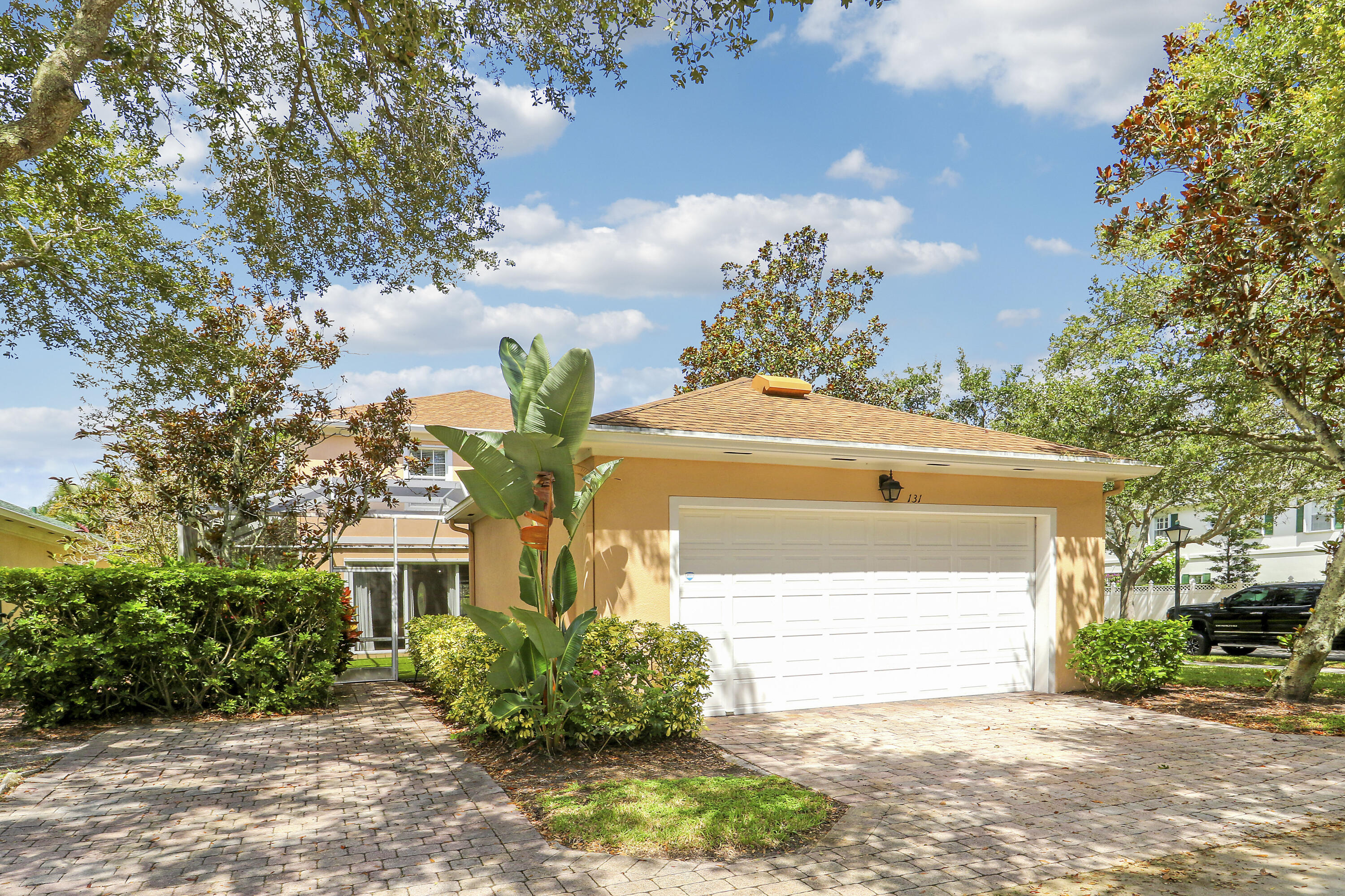 131 Rockingham Road Jupiter, FL 33458 - Photo 37 of 40 a front view of a house with a yard and garage