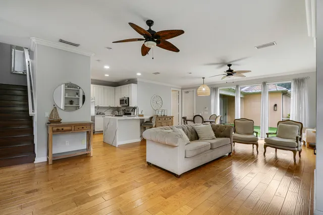 a living room with furniture and kitchen view