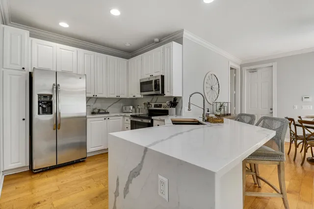 a kitchen with refrigerator a stove a sink and a microwave