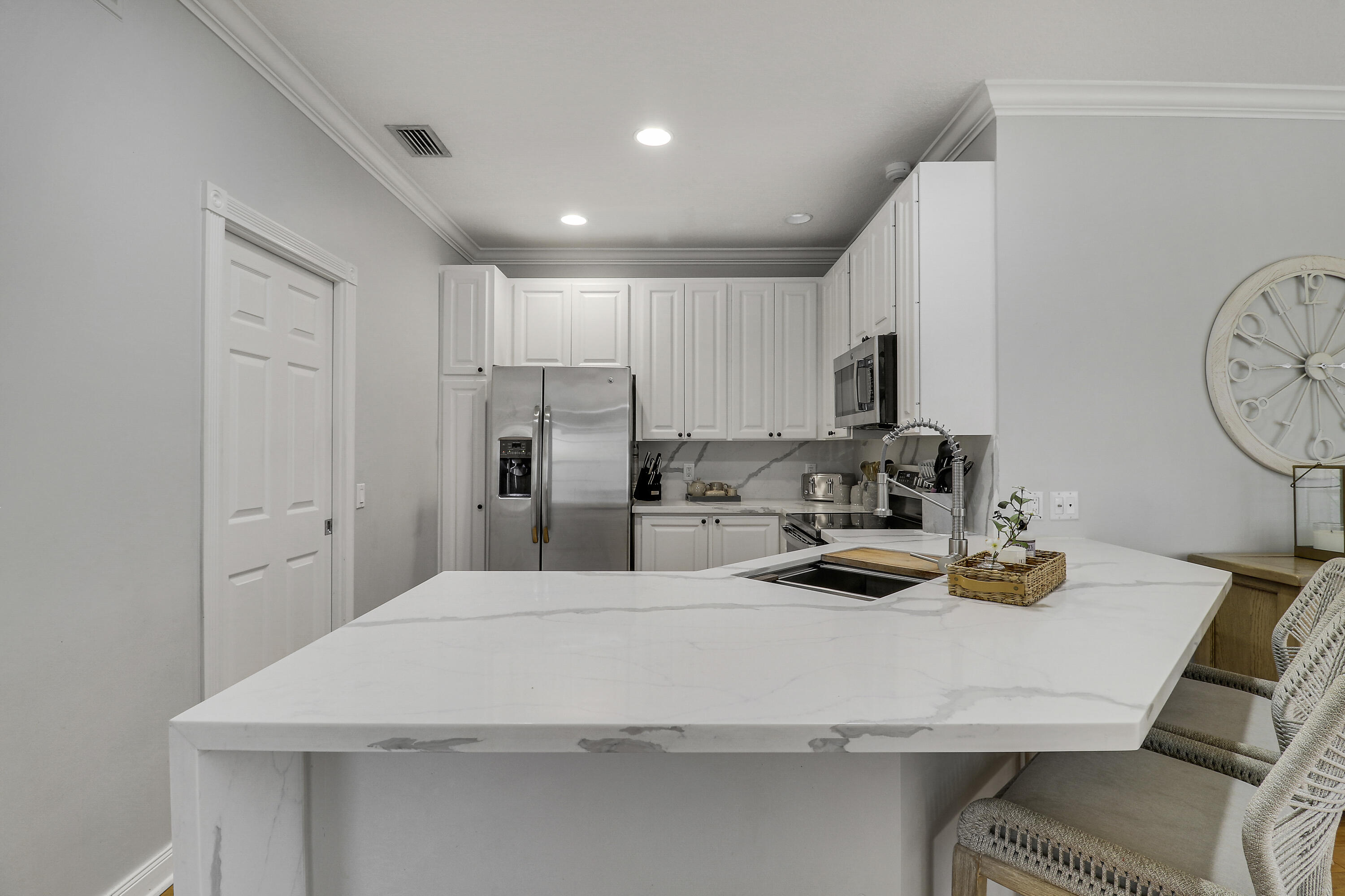 131 Rockingham Road Jupiter, FL 33458 - Photo 9 of 40 a kitchen with sink cabinets and refrigerator