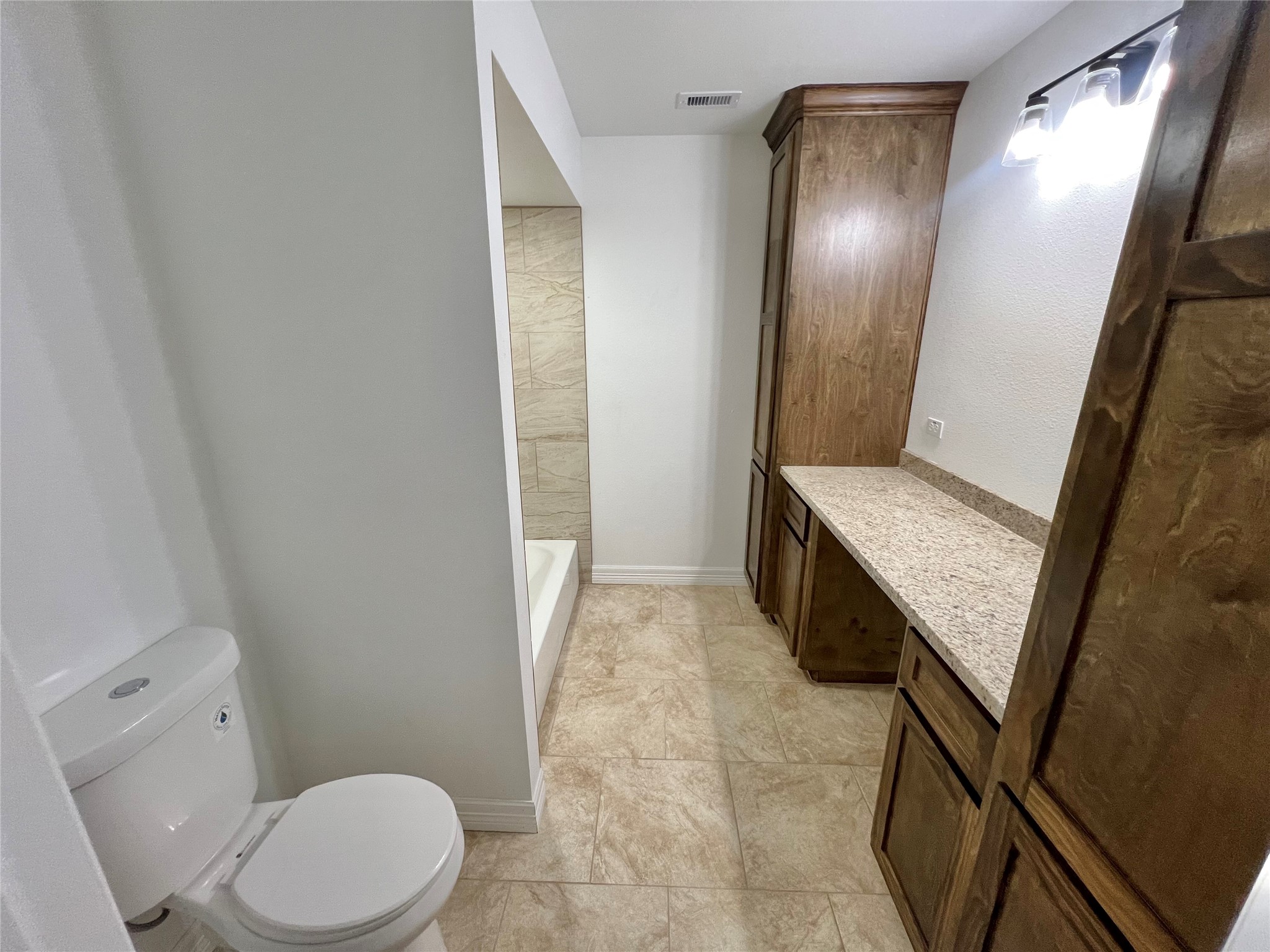 5 Colony Drive Angleton, TX 77515 - Photo 11 of 34 a bathroom with a granite countertop sink toilet and shower