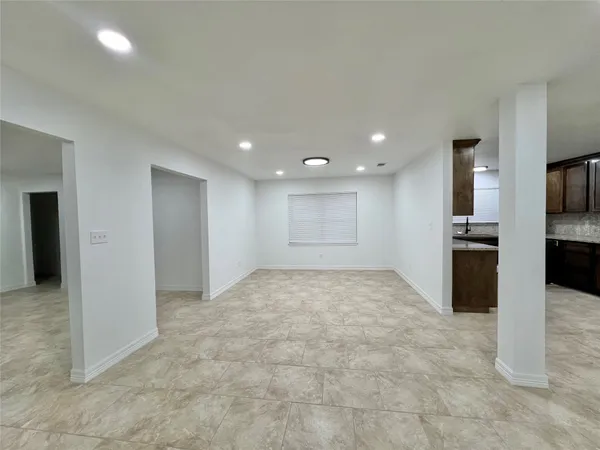 a view of a kitchen with a sink and a refrigerator
