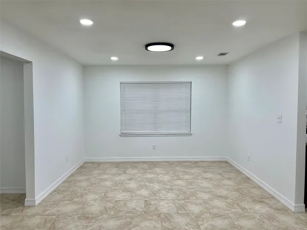 an empty room with a empty space and window