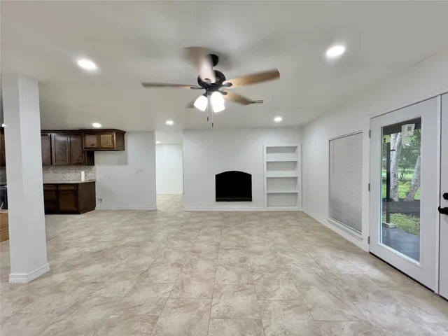 a large kitchen with stainless steel appliances granite countertop a stove and a sink