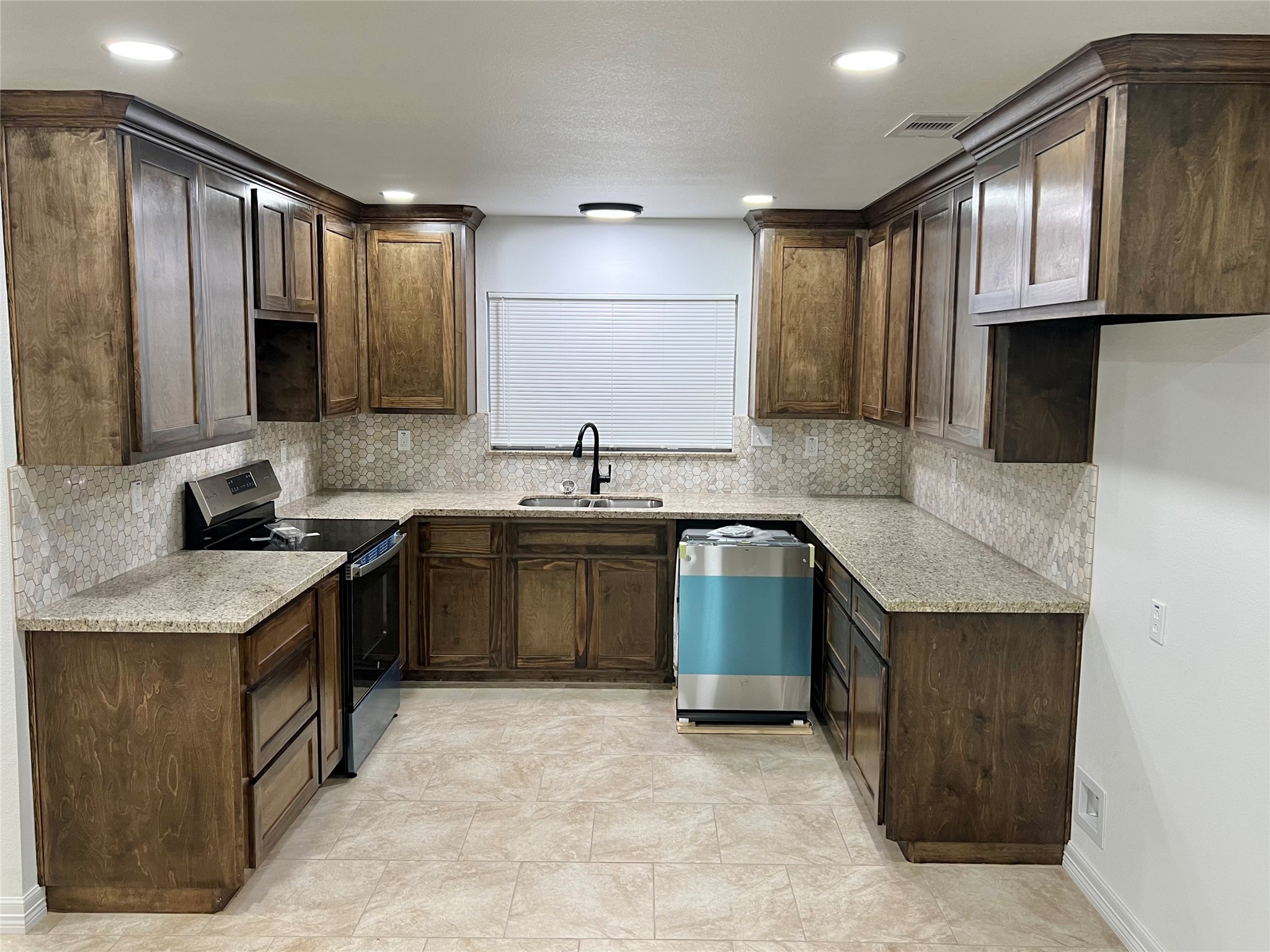 5 Colony Drive Angleton, TX 77515 - Photo 21 of 34 a kitchen with a sink stove and cabinets