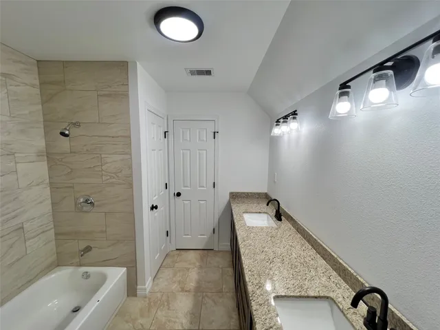 a bathroom with a bathtub and shower