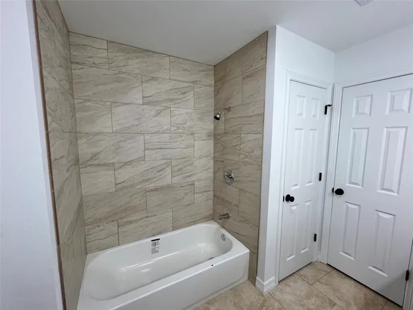 a bathroom with a bathtub and shower