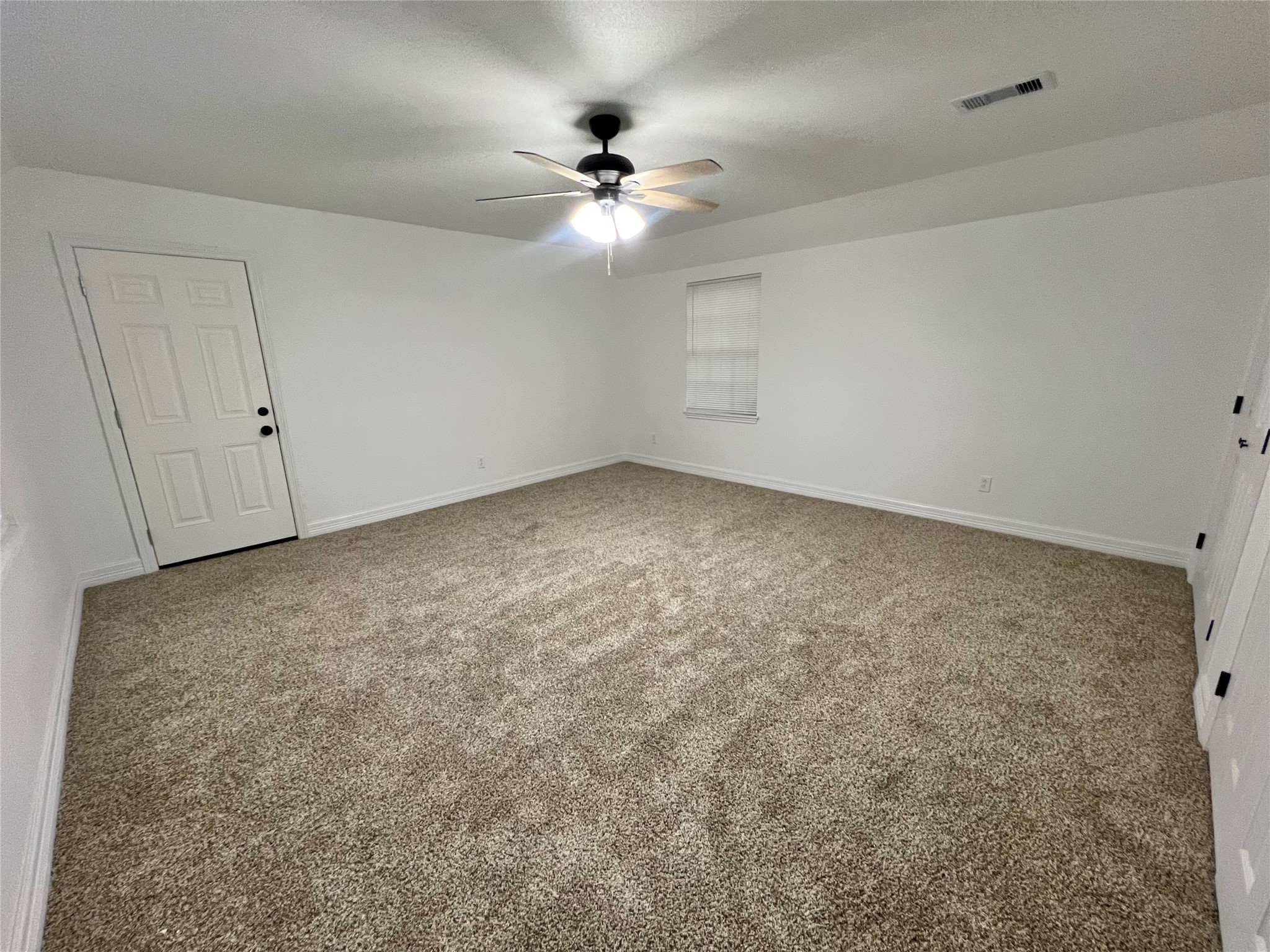 5 Colony Drive Angleton, TX 77515 - Photo 31 of 34 an empty room with a chandelier fan and windows