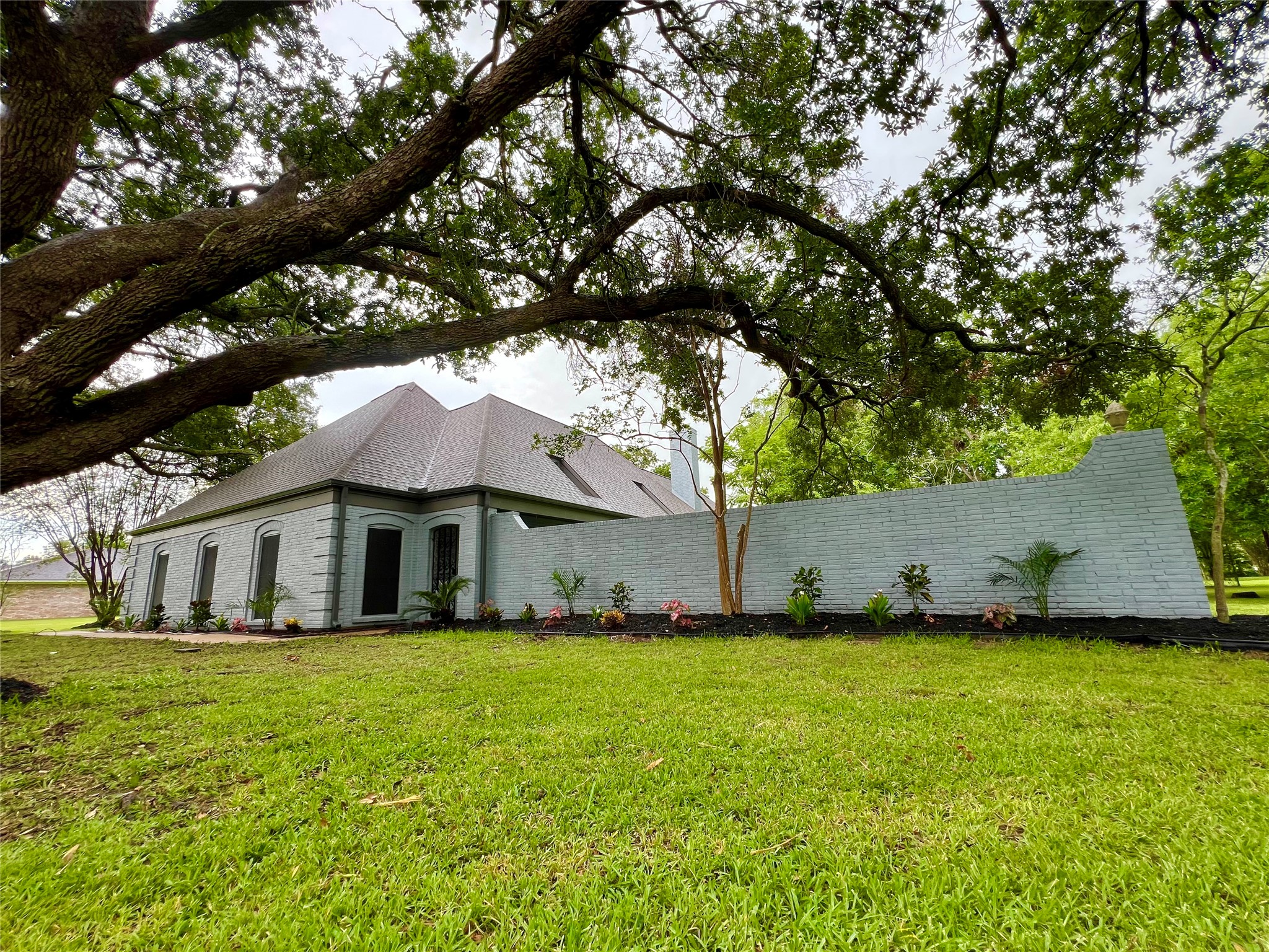 5 Colony Drive Angleton, TX 77515 - Photo 33 of 34 a white house that has a tree in front of it