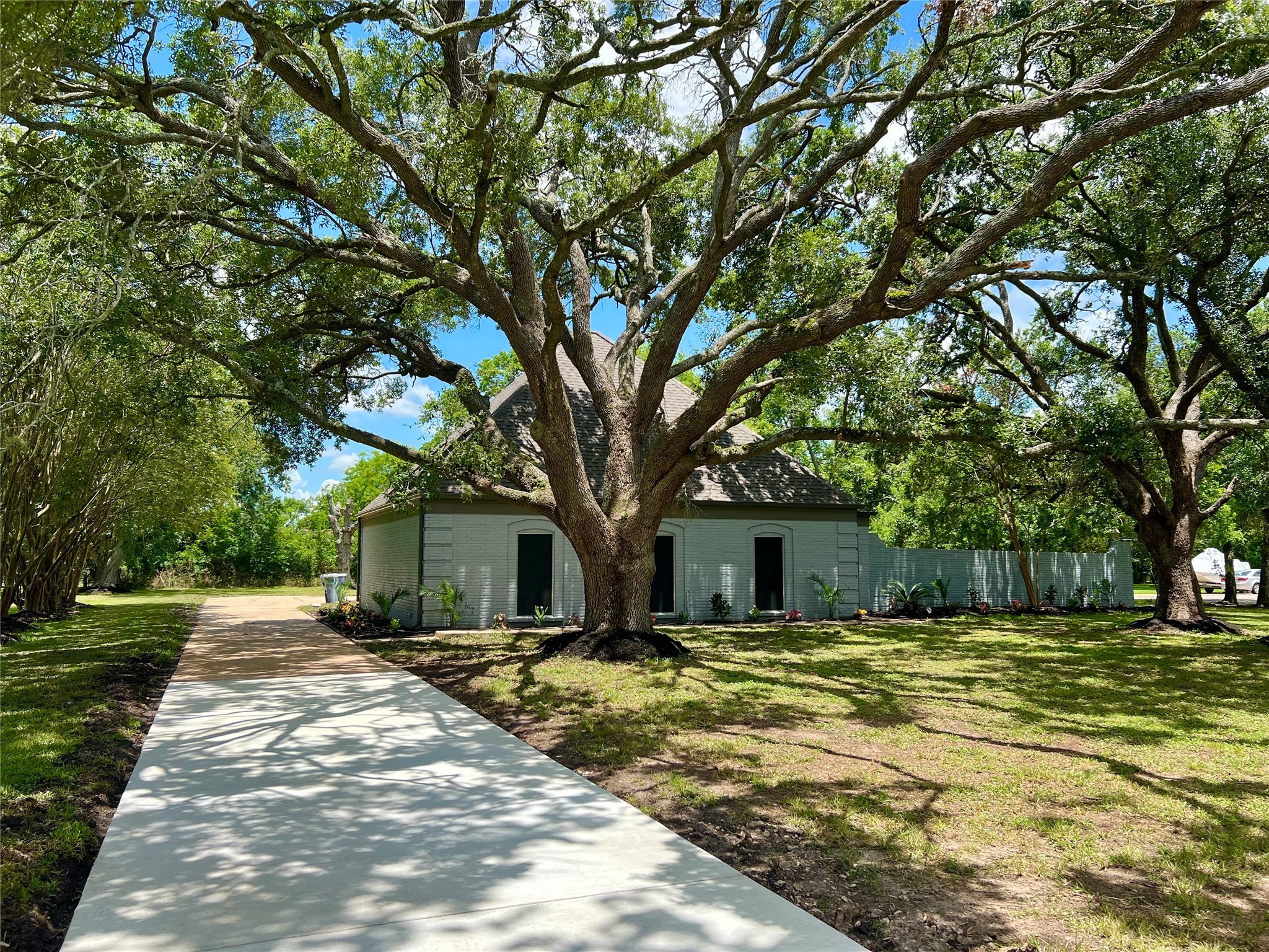 5 Colony Drive Angleton, TX 77515 - Photo 34 of 34 a backyard of a house with large trees and outdoor seating