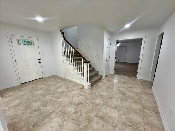 a view of a hallway with staircase