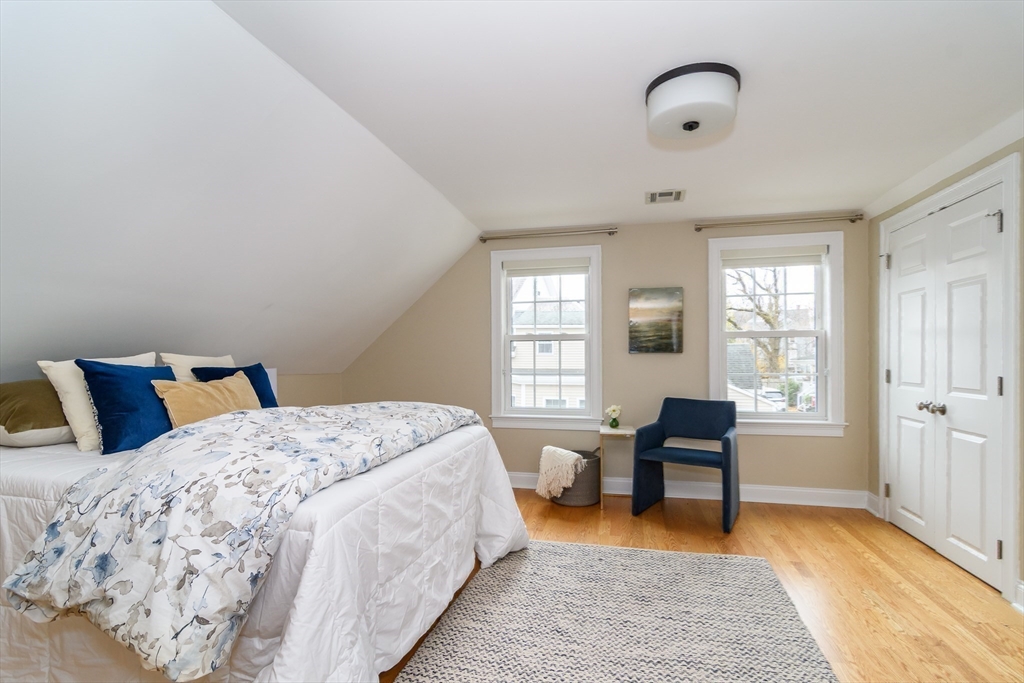 4 Willow Street Natick, MA 01760 - Photo 16 of 24 a bed room with a bed and a chair in it