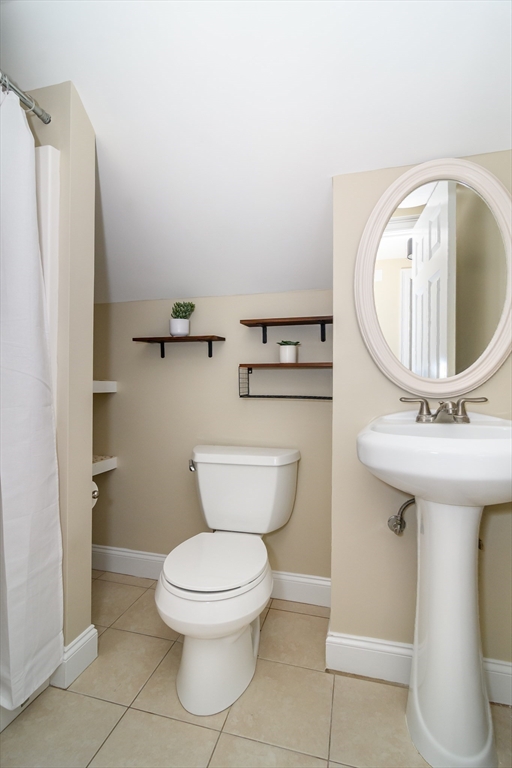 4 Willow Street Natick, MA 01760 - Photo 18 of 24 a bathroom with a toilet sink and mirror