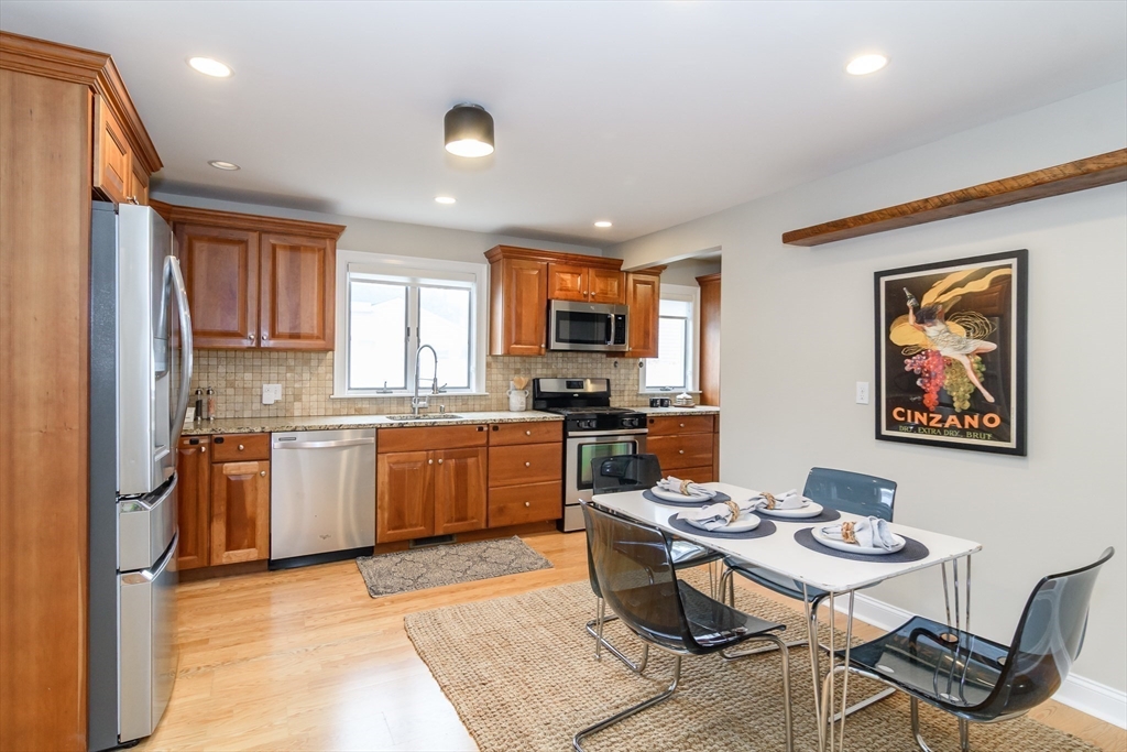 4 Willow Street Natick, MA 01760 - Photo 4 of 24 a kitchen with a refrigerator and a stove top oven