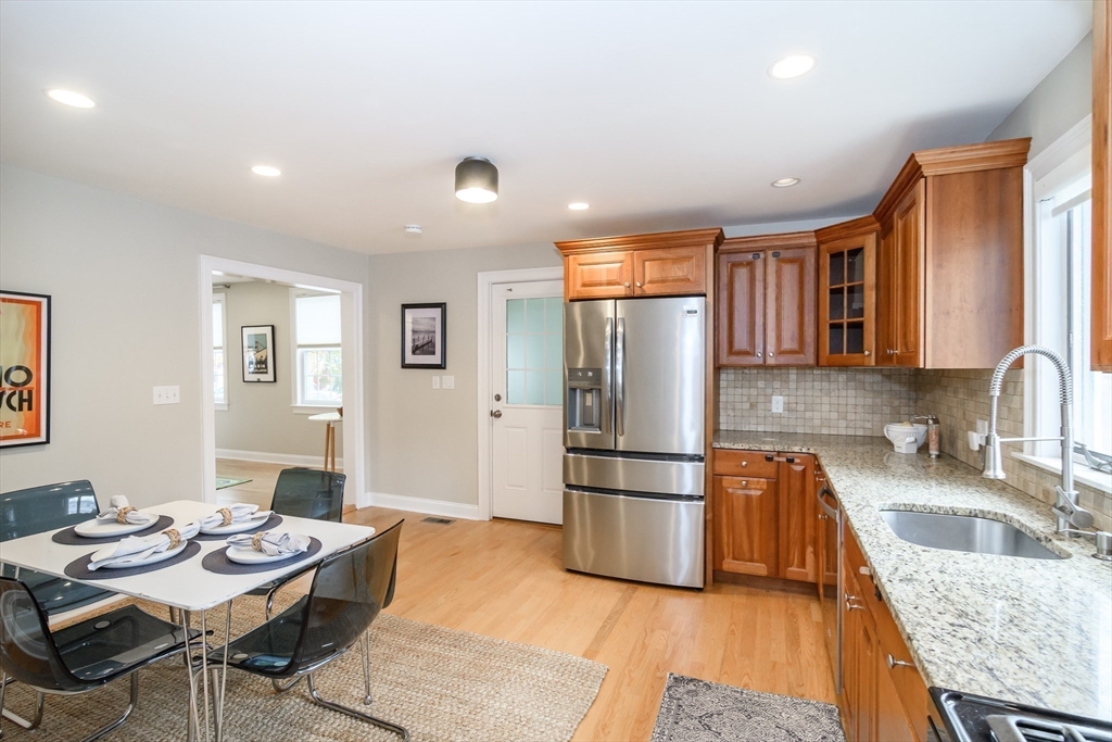 4 Willow Street Natick, MA 01760 - Photo 5 of 24 a kitchen with stainless steel appliances granite countertop a refrigerator and a sink