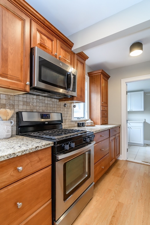 4 Willow Street Natick, MA 01760 - Photo 6 of 24 a kitchen with stainless steel appliances granite countertop a stove microwave and sink