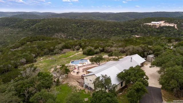 an aerial view of house with yard and mountain view