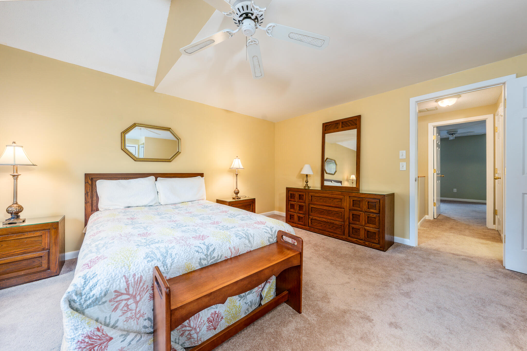 121 Shellback Way, Unit 121 Mashpee, MA 02649 - Photo 14 of 23 a bedroom with a bed and a chandelier