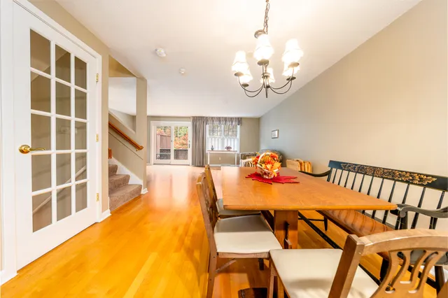 a view of a dining room with furniture and a chandelier