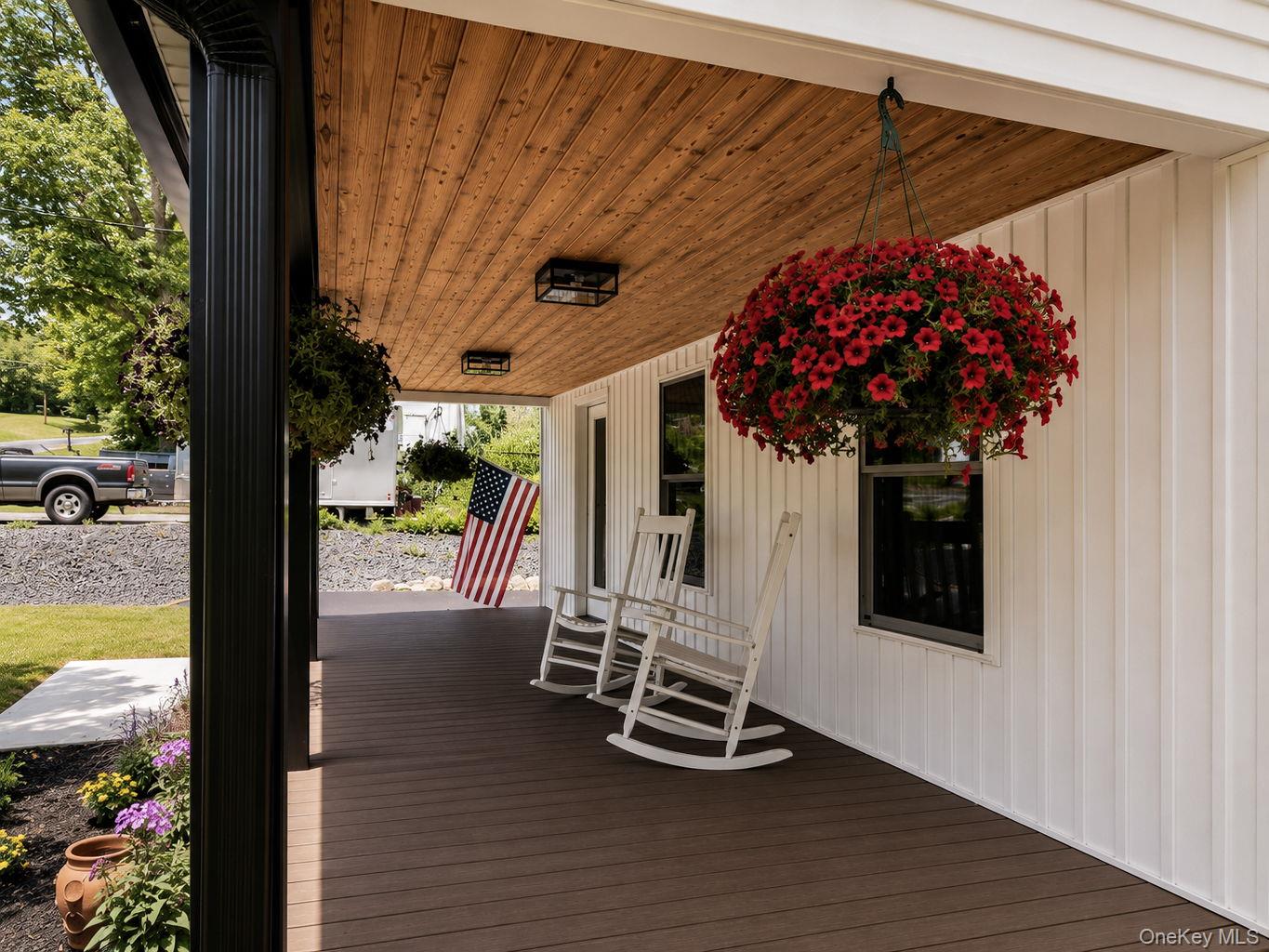33 County Rte 17 Pine Bush, NY 12566 - Photo 6 of 47 Covered front porch featuring a wood-finish ceiling, dark composite decking, vertical white siding, and black trim