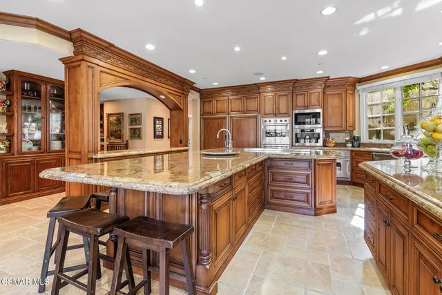 a bathroom with a tub a sink and a large window
