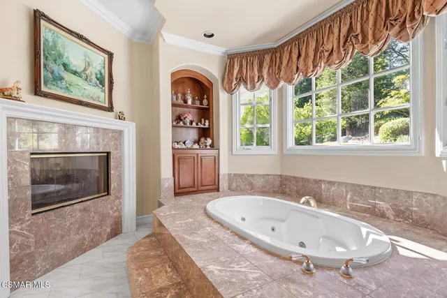 a view of a patio with table and chairs under an umbrella