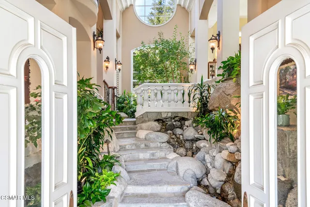 a living room with furniture fireplace and rug