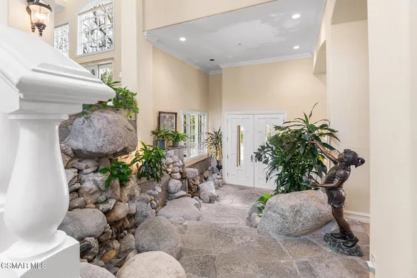 a living room with furniture and kitchen view
