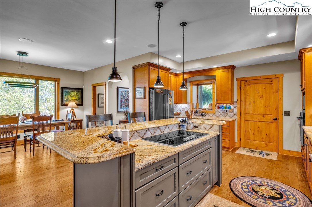 2650 Carson Woods Road Laurel Springs, NC 28644 - Photo 10 of 50 a kitchen with center island table and chairs