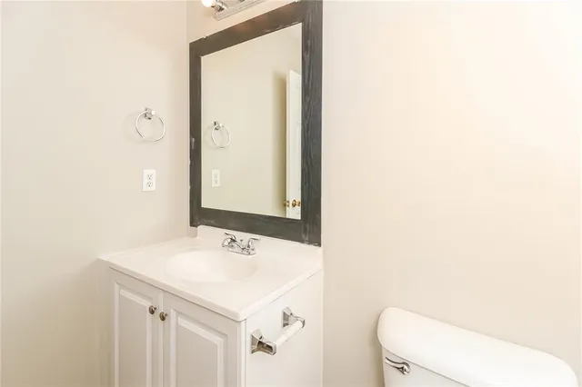 a bathroom with a sink a toilet and mirror