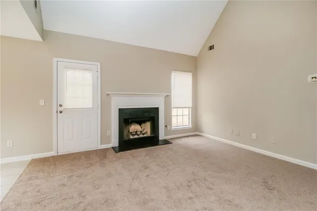 a view of an empty room with a fireplace