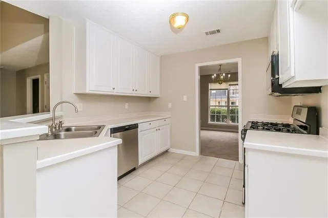 a kitchen with a sink stove and cabinets