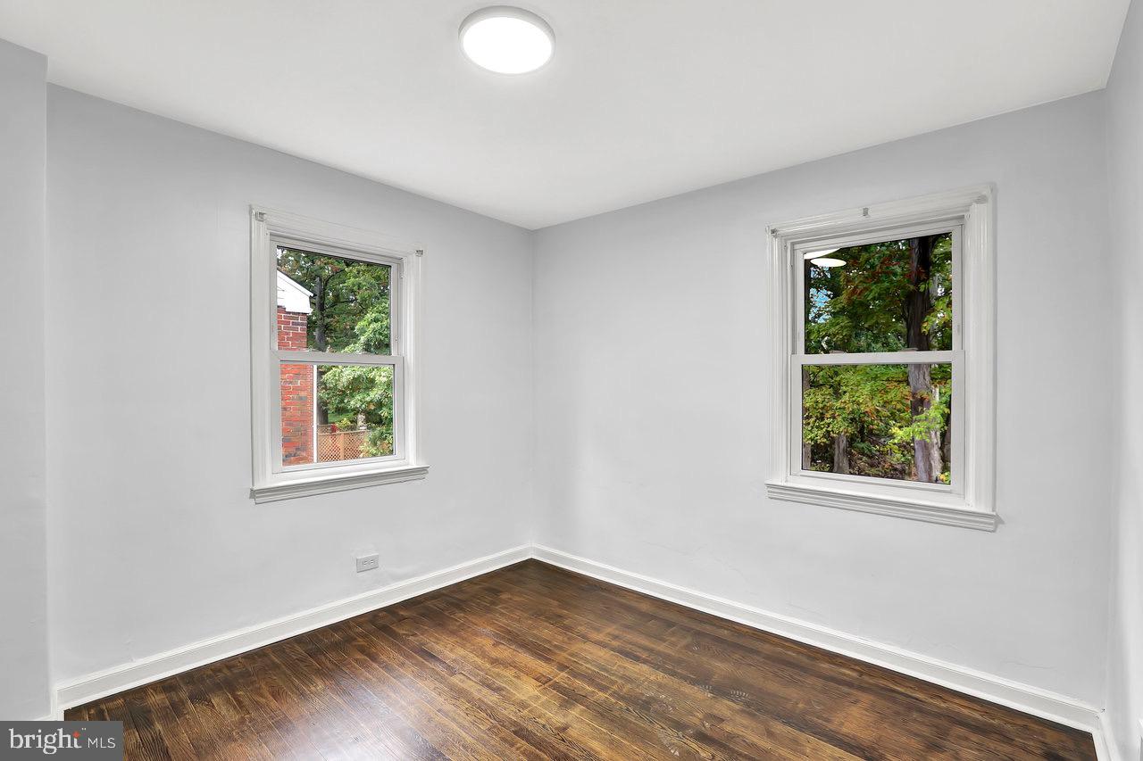 331 Oakland Street Ewing, NJ 08618 - Photo 13 of 21 an empty room with wooden floor and windows