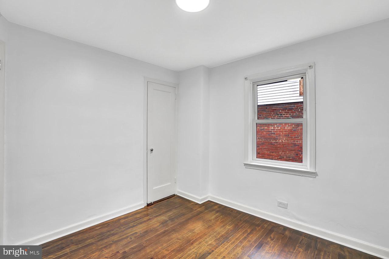 331 Oakland Street Ewing, NJ 08618 - Photo 14 of 21 an empty room with wooden floor and windows
