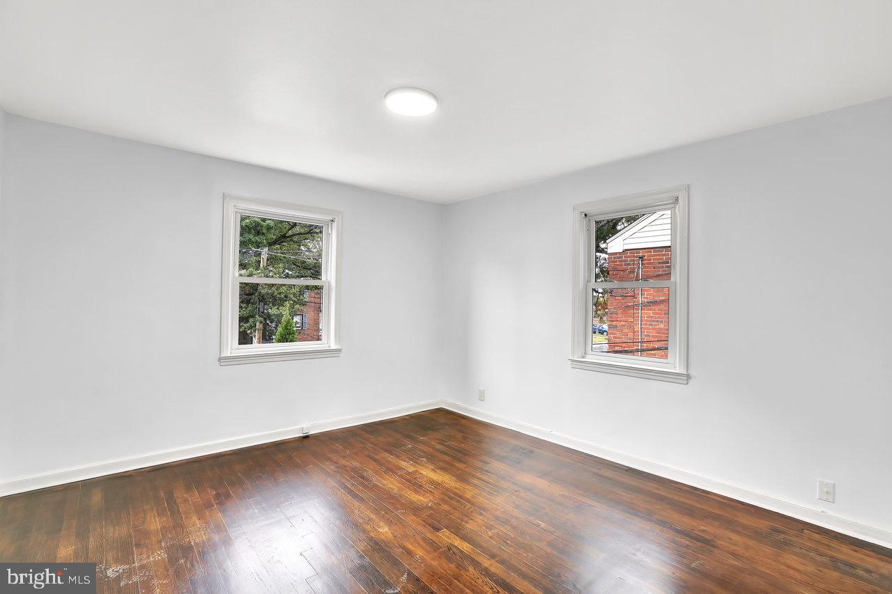 331 Oakland Street Ewing, NJ 08618 - Photo 16 of 21 an empty room with wooden floor and windows