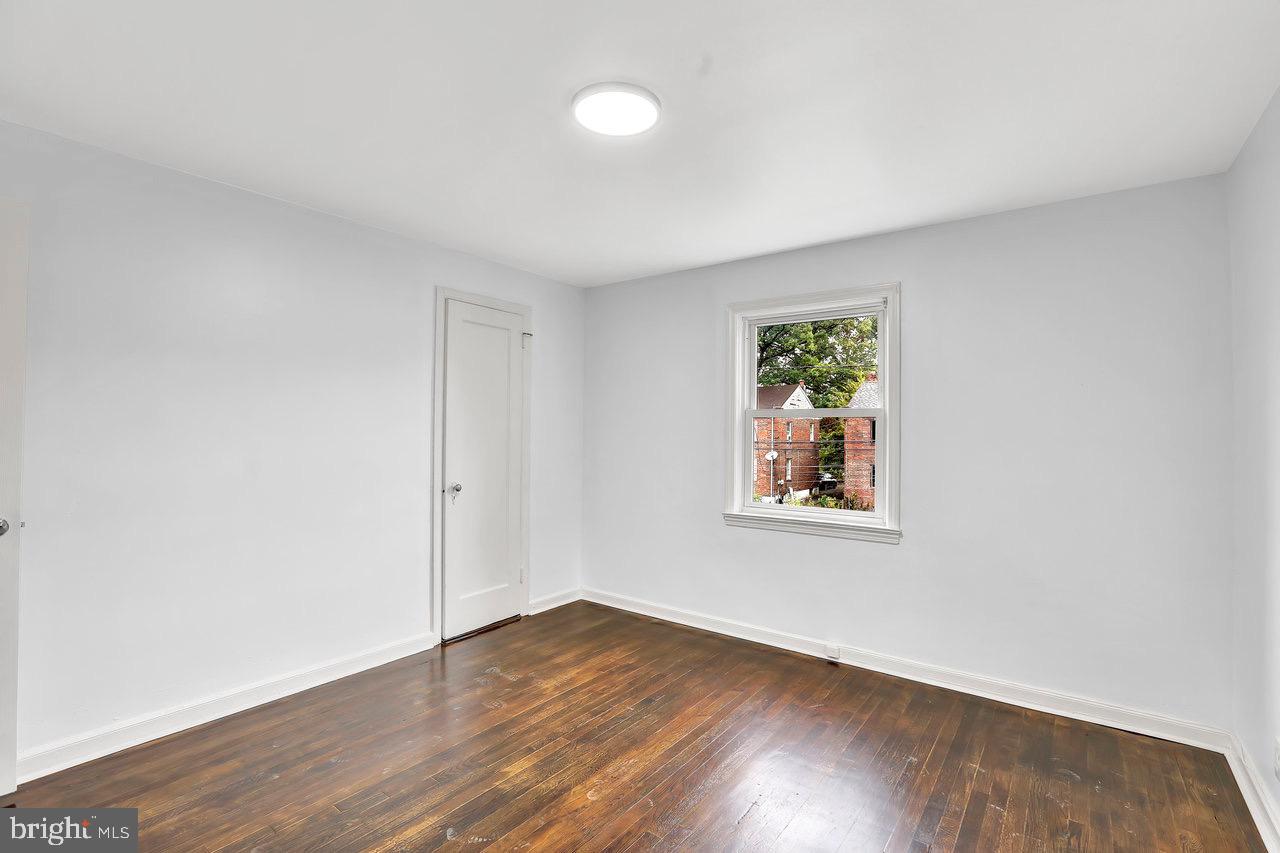 331 Oakland Street Ewing, NJ 08618 - Photo 17 of 21 an empty room with wooden floor and window