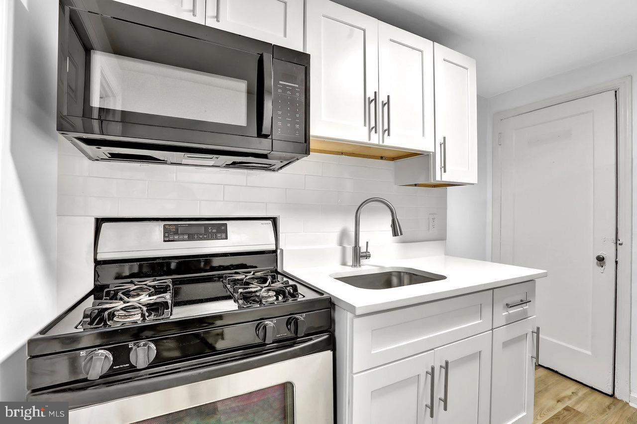 331 Oakland Street Ewing, NJ 08618 - Photo 10 of 21 a kitchen with a stove and a microwave
