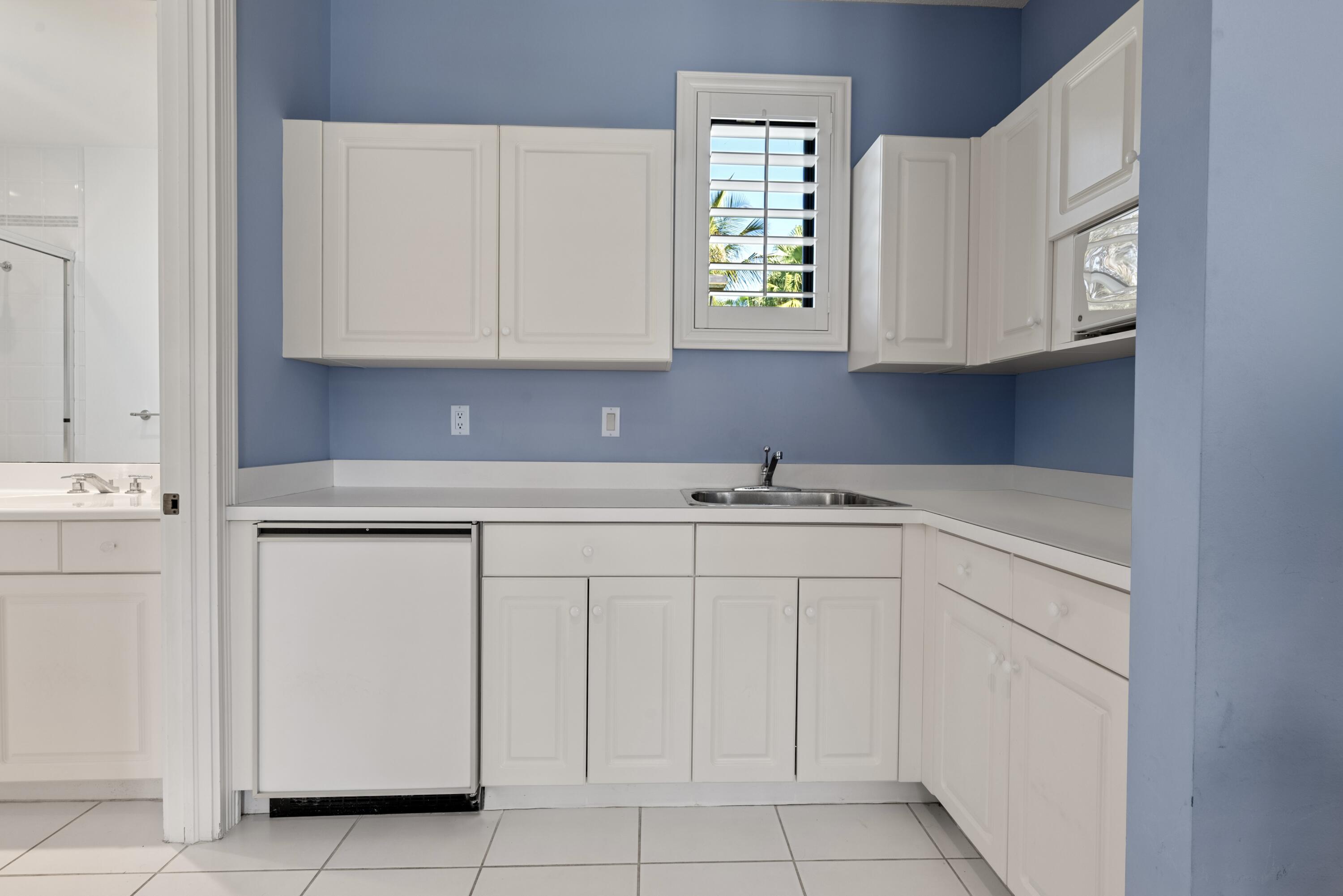 18800 Long Lake Drive Boca Raton, FL 33496 - Photo 55 of 60 a kitchen with white cabinets and sink