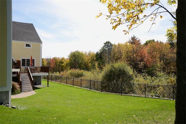 10 Towne Road Middleton, MA 01949 - Photo 3 of 30 a view of a swimming pool with a bench and trees in the background