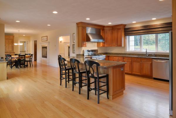 10 Towne Road Middleton, MA 01949 - Photo 4 of 30 a dining hall with stainless steel appliances granite countertop a stove a sink a dining table and chairs with wooden floor