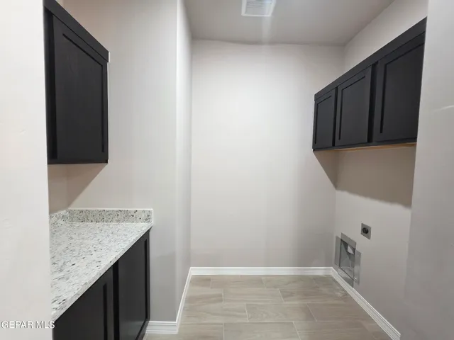a bathroom with a granite countertop sink and cabinets