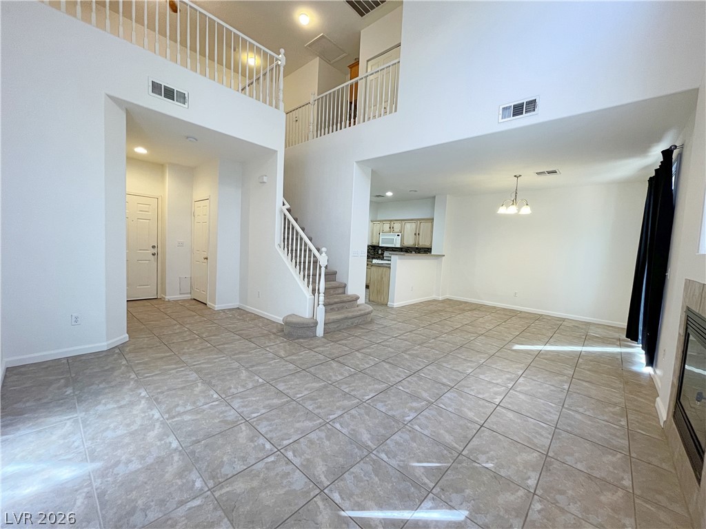 691 Principle Point Avenue Henderson, NV 89012 - Photo 4 of 30 A spacious great room features soaring ceilings and an inviting open-concept layout.